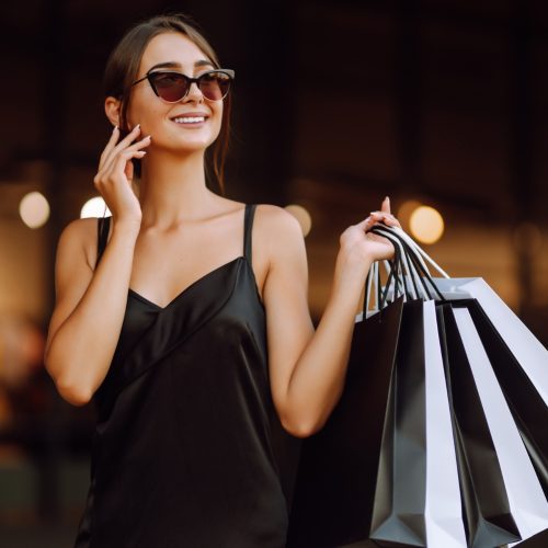 fashionable-woman-dressed-black-dress-with-shopping-bags